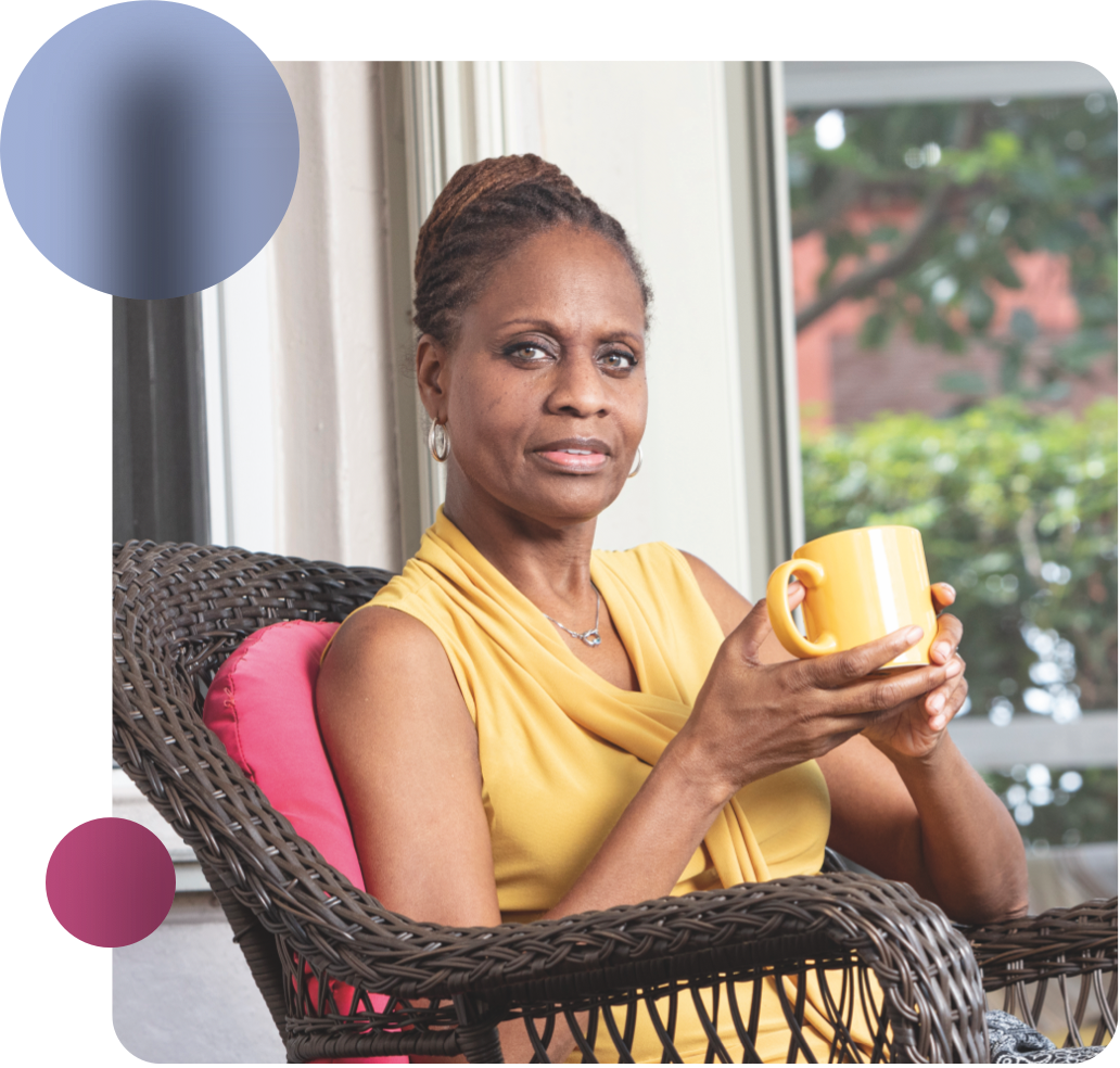 Acthar Gel patient: Abby sitting in chair holding mug